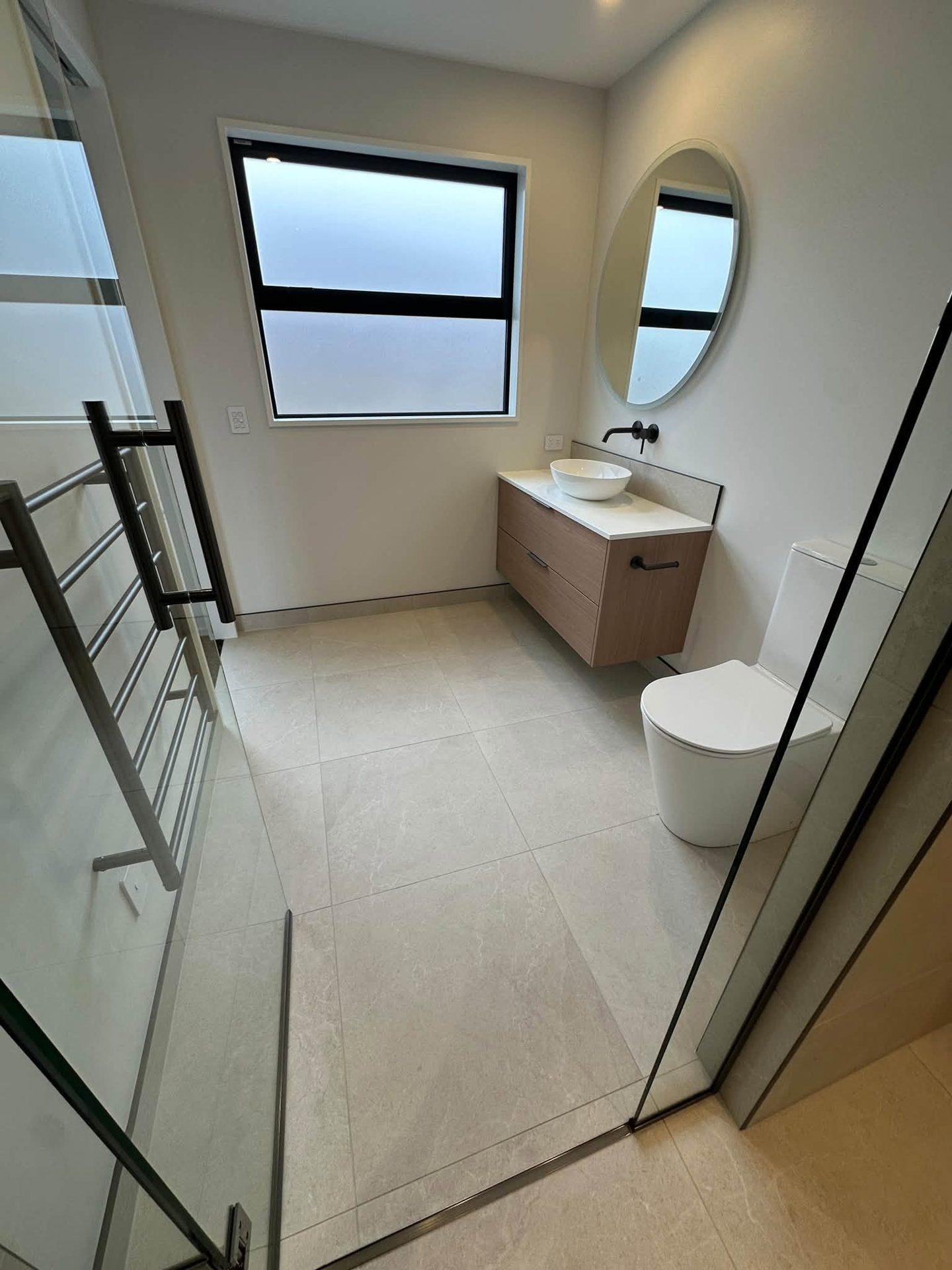 Finished bathroom floor tiles with heated towel rail