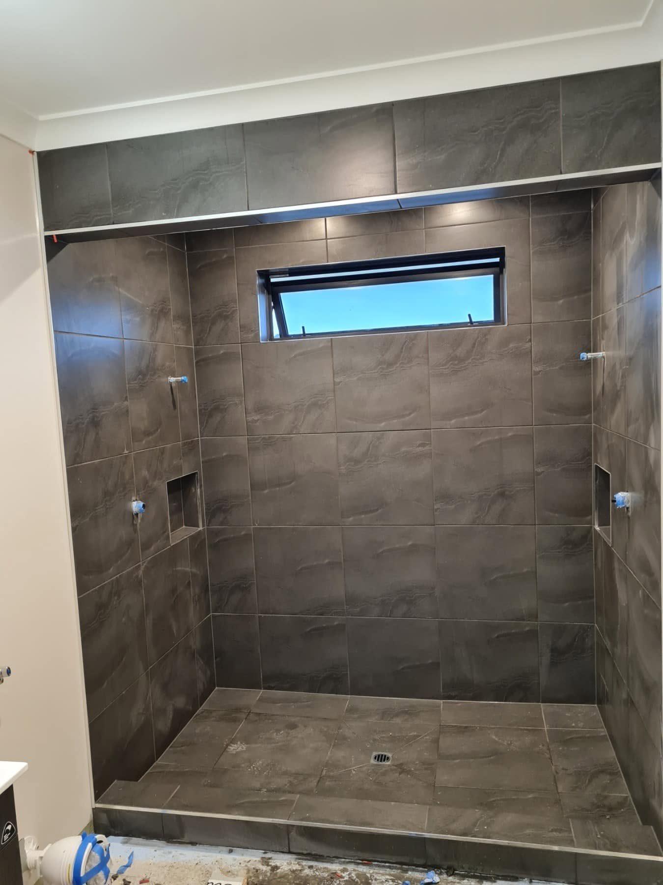 Dark grey full-height shower tiles