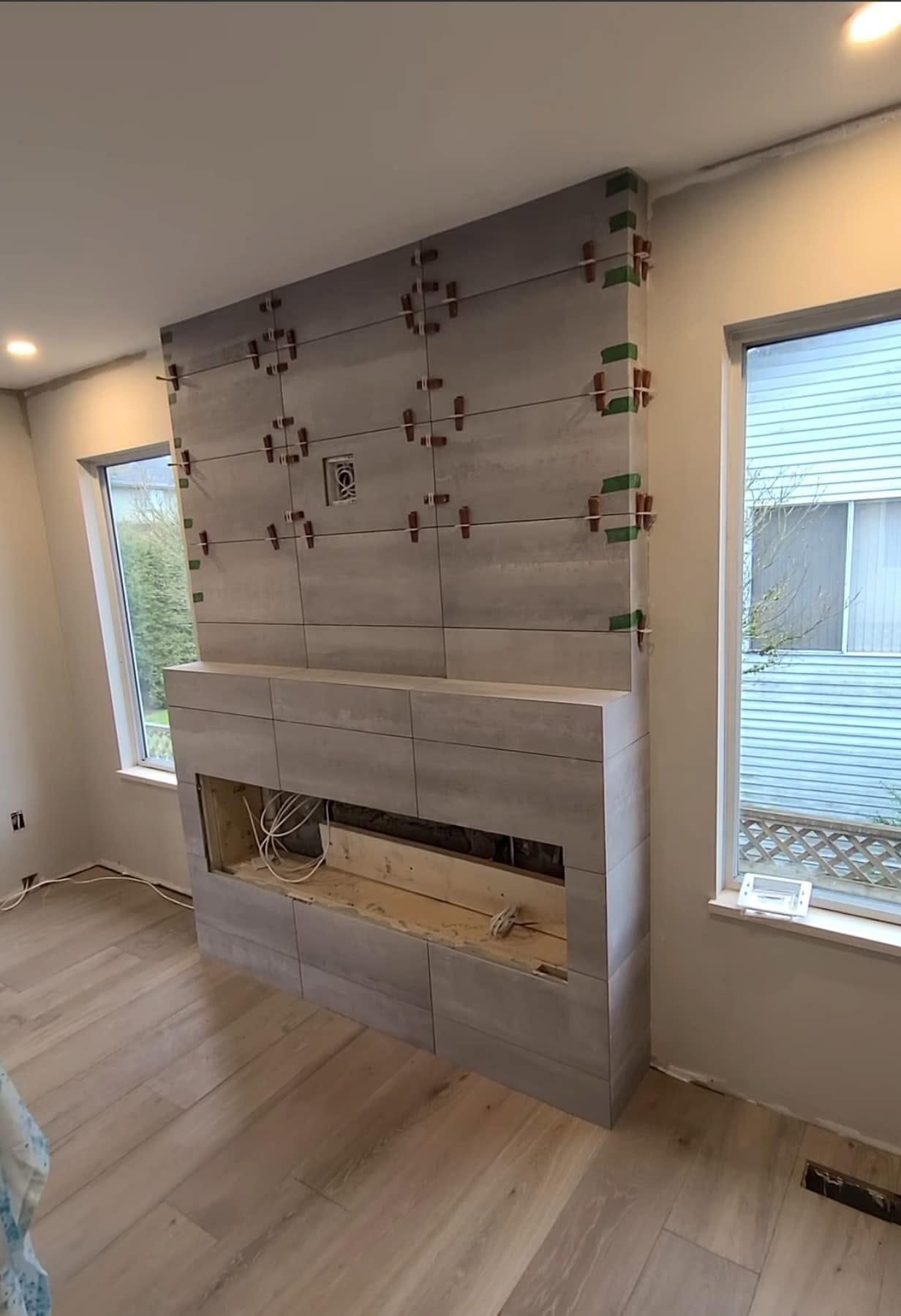 Fireplace feature wall tiling in progress
