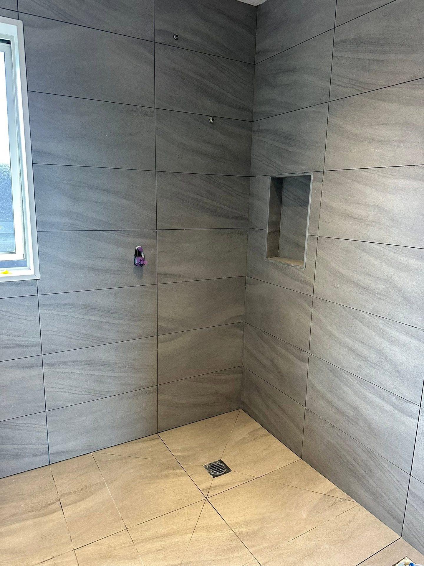 Grey large-format tiled walk-in shower