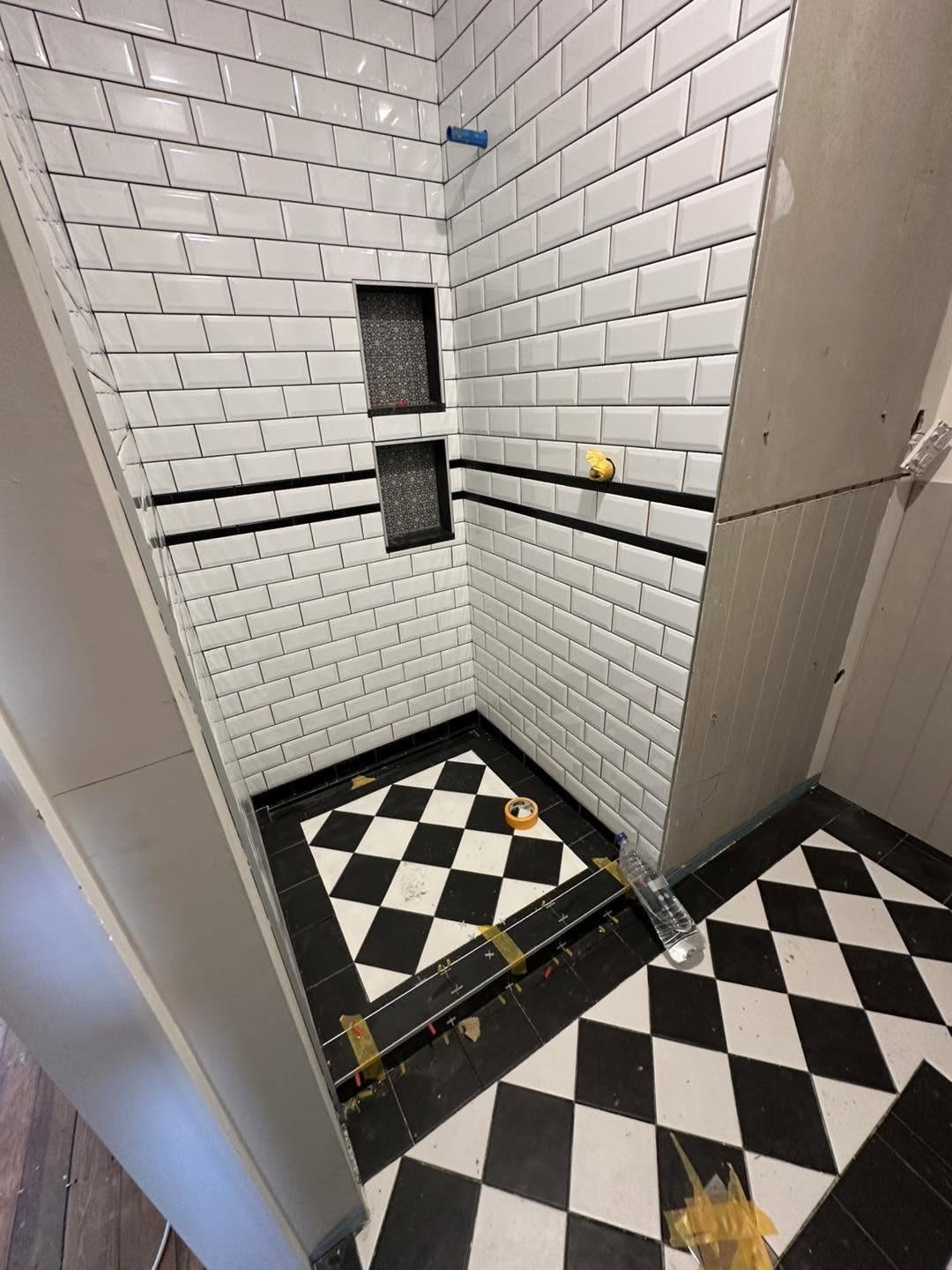 Heritage-style subway tile shower with black and white floor