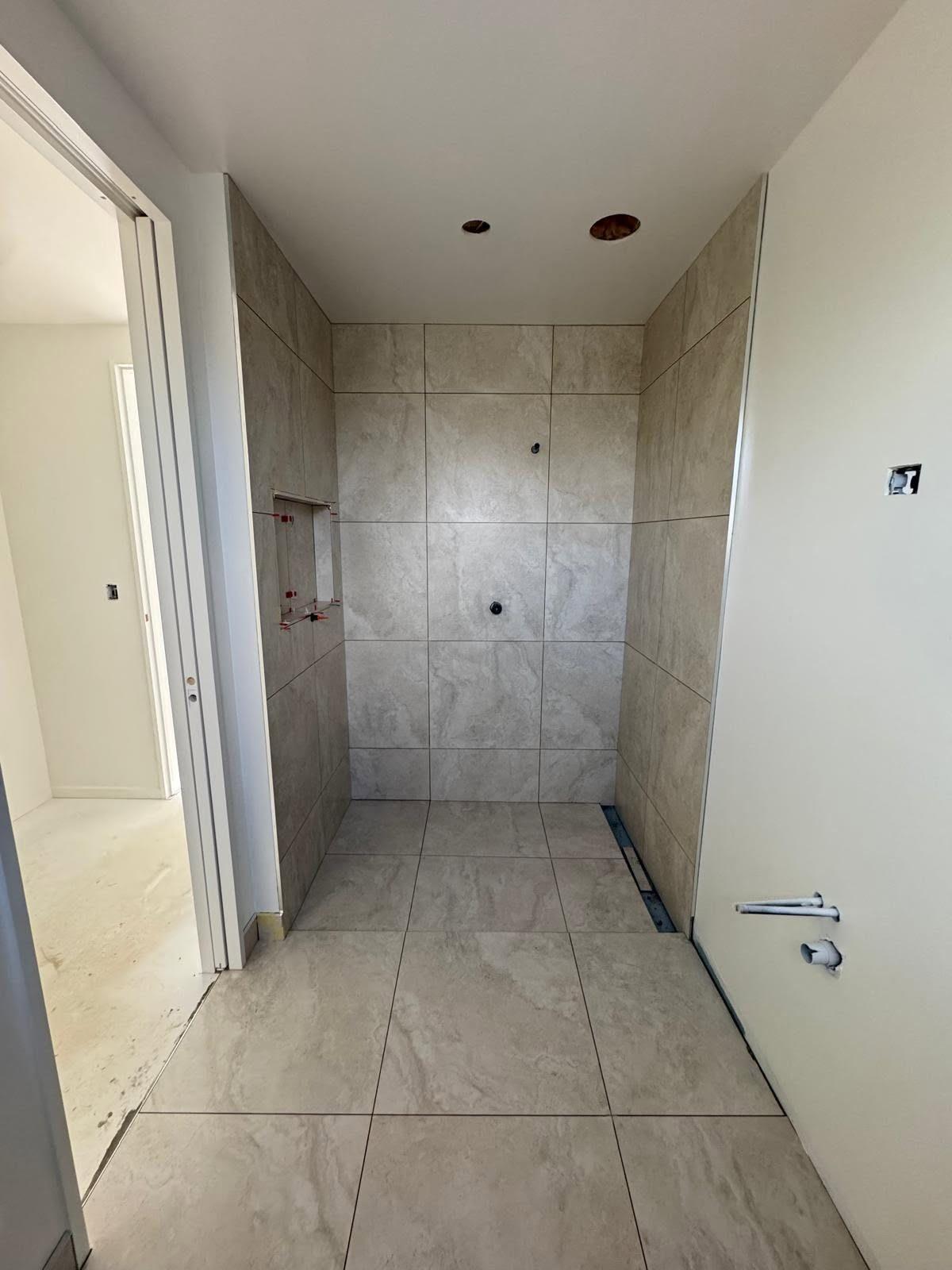 Marble-look walk-in shower in a new build