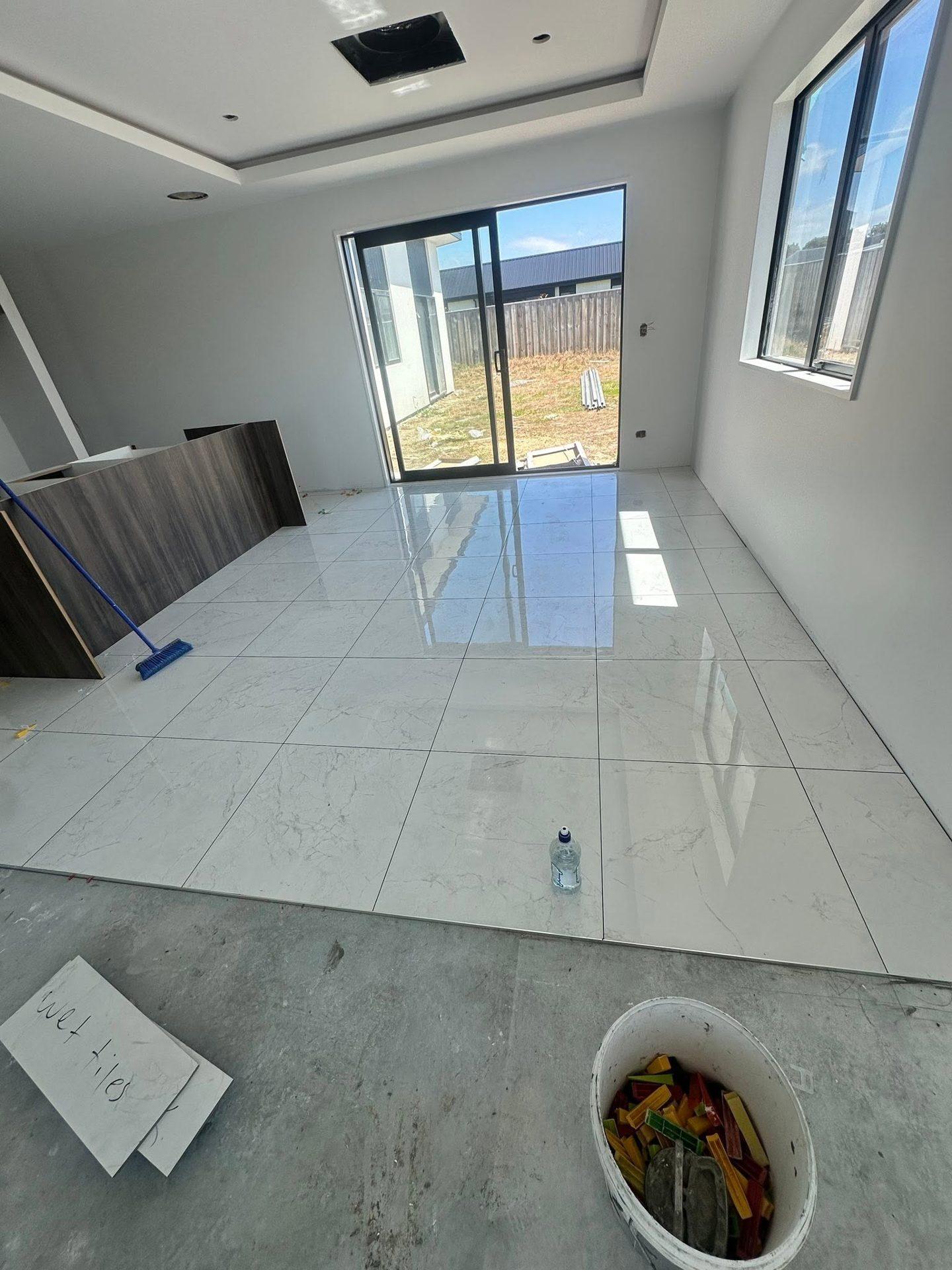 Large-format marble-look floor tiles in an open-plan living area