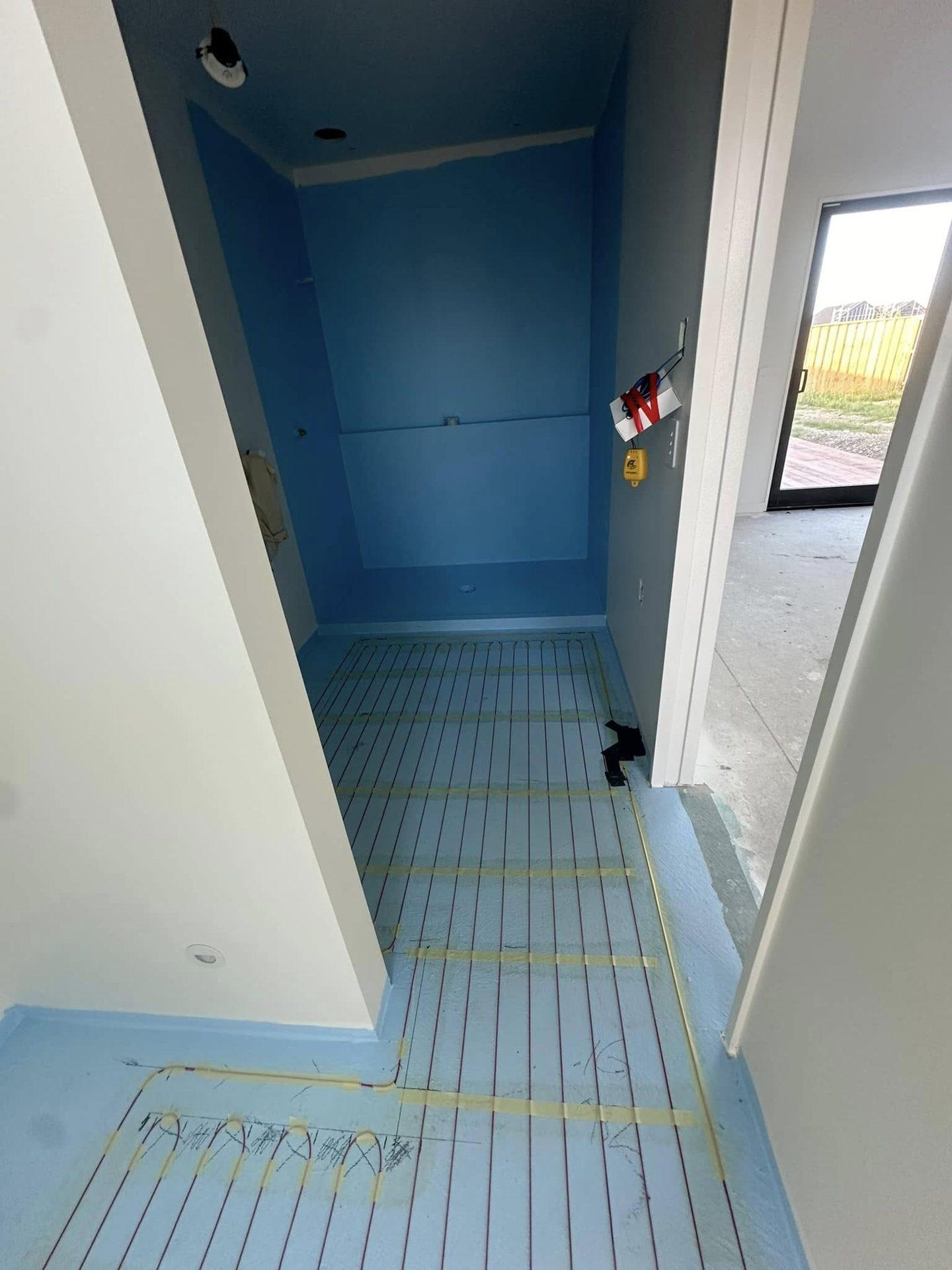 Waterproofing membrane on shower walls with underfloor heating cables